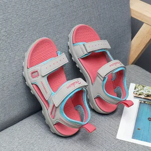 Detailed view of girls' pink and grey summer sandals with Velcro straps.