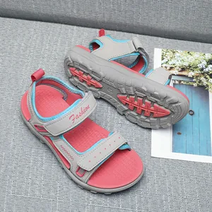 Close-up detail of children's pink and grey sport sandals showing the anti-slip rubber sole texture