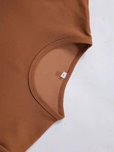 Detailansicht des braunen Waffelstrickstoffs und des Rundhalsausschnitts bei diesem Herrenoberteil