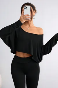 Detail showing the black long-sleeved off-the-shoulder cropped top for a trendy look