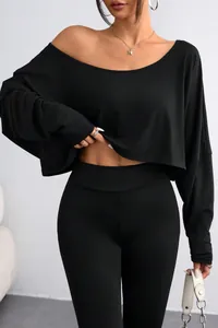 Detail of the elegant black off-the-shoulder long sleeve crop top with leggings