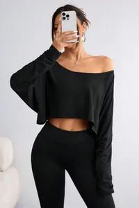 Detailed close-up of a women's black off-the-shoulder long sleeve loose fit crop top