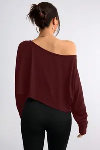 Back view of a loose burgundy off-the-shoulder cropped top with long sleeves