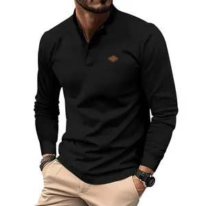 Detailed view of black waffle knit fabric on men's long-sleeve Henley shirt with buttons