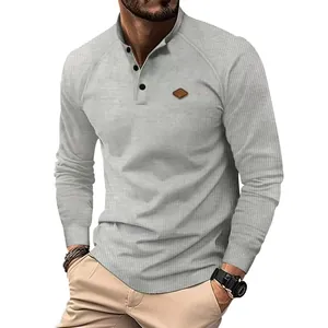 Close-up detail of men's grey waffle knit long sleeve Henley shirt with buttons