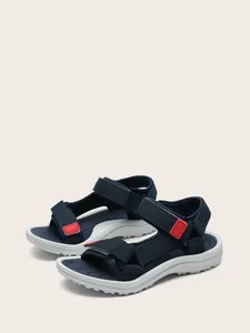 Full view of navy children's sport sandals showing velcro straps and textured outsole