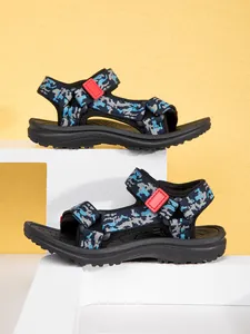 Detail view of stylish children's camouflage sandals with anti-slip soles and red accents