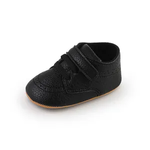 Close-up of black pebbled leather baby toddler shoe with velcro strap detail