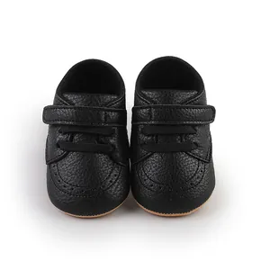 Close-up of black lychee-patterned baby walking shoes featuring adjustable strap closure