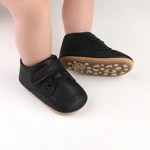 Detailed view of black faux leather baby walker shoes with secure velcro straps