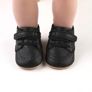 Close-up detail of black baby walker shoes featuring velcro straps and faux laces