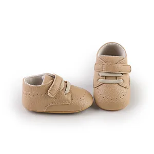 Detail view of light brown pebbled faux leather baby walking shoes with velcro straps
