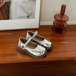Close-up of silver metallic toddler Mary Jane shoes with braided strap detail
