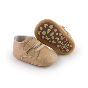 Detailed view of tan baby pre-walker shoes with anti-slip soles and velcro straps.