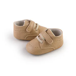 Close-up detail of khaki faux leather baby walking shoes with velcro strap and laces