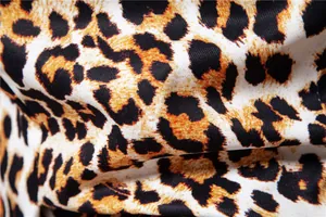 Close-up macro detail showing the leopard print pattern and twill fabric of a men's blazer