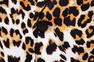Close-up detail of leopard print men's suit jacket showing black button texture