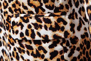 Macro view showing the flap pocket detail on a stylish leopard print men's blazer