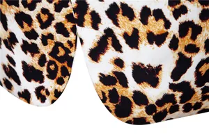 Macro close-up detail of a men's blazer with vibrant leopard print pattern and fabric texture