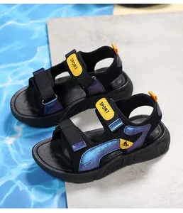Detailed view of boys' black sport sandals featuring blue iridescent straps and yellow tags