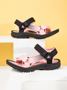 Macro view of pink and black children's sports sandals with adjustable velcro straps