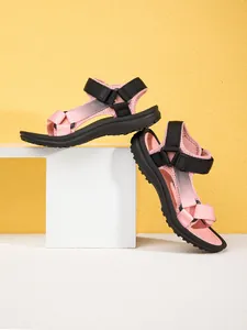 Side detail view of pink and black children's athletic sandals with adjustable straps