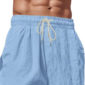 Dettaglio dei pantaloni larghi in lino blu da uomo con vita elastica e coulisse