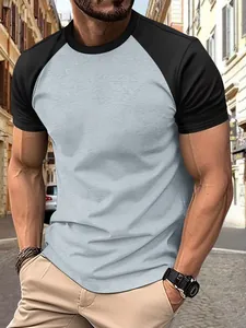 Close-up of men's athletic raglan t-shirt in grey and black featuring a slim fit
