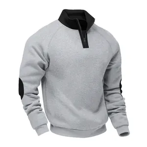Detailed view of casual grey sweatshirt featuring black quarter-zip collar and elbow patches