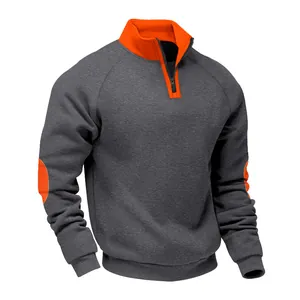 Detail of charcoal grey quarter-zip fleece pullover with orange collar and elbow patches