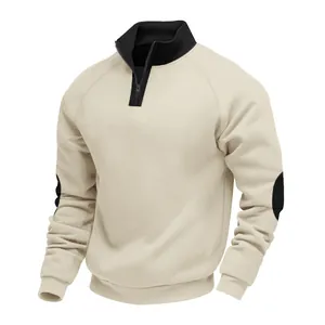Detail view of heavyweight beige sweatshirt featuring black stand collar and contrast elbow patches