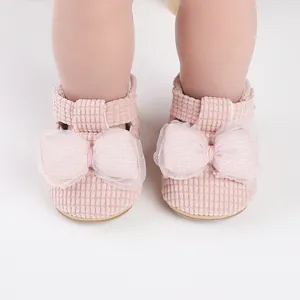 Close-up detail of pink waffle texture baby walking shoes with decorative mesh bows