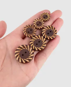 Close-up of decorative natural poplar wood buttons with radial stripe patterns