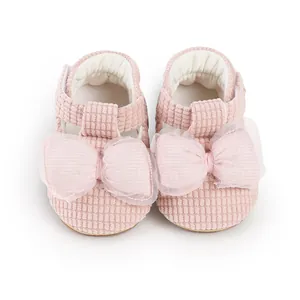 Detailed view of pink baby pre-walker shoes with a soft mesh bow and corduroy texture