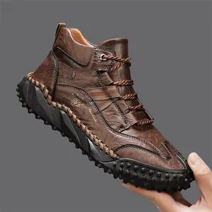 Close-up of brown textured leather outdoor casual boot featuring decorative logo and stitching