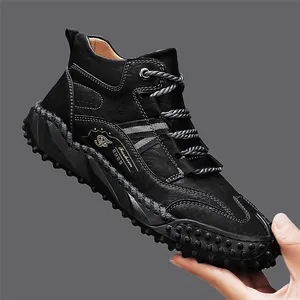 Detailed view of black leather outdoor boot with rugged studded sole and rope laces