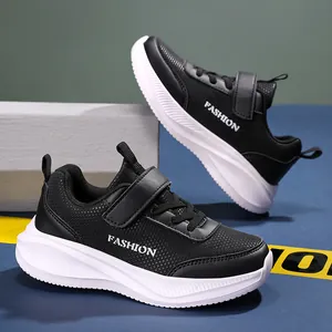 Side view of lightweight black boys' sneakers with durable leather and non-slip sole
