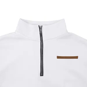 Close-up of white men's half-zip sweatshirt with stand collar and brown patch detail.