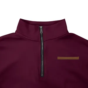 Detailed macro view of the metal zipper and stand collar on a burgundy casual sweatshirt