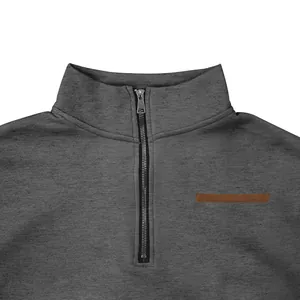 Close-up detail of gray half-zip stand collar sweatshirt with leather accent