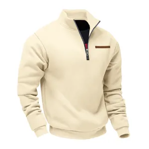 Detail view of men's cream quarter-zip sweatshirt with stand collar and metal zipper.