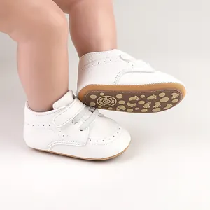 Detail shot of white baby walking shoes with anti-slip rubber sole and velcro strap