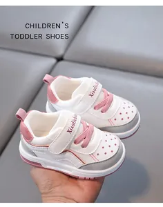 Detailed view of breathable toddler walking shoes with soft pink soles and velcro straps