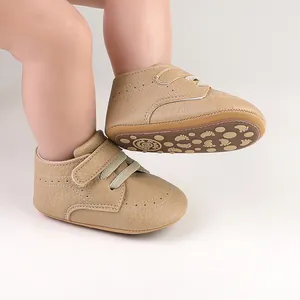 Detailed macro shot of khaki baby walking shoes featuring non-slip footprint patterned soles