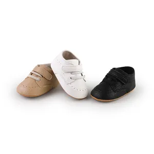Soft faux leather baby walking shoes in tan, white, and black with velcro straps