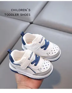 Close-up of blue and white toddler walking shoes with breathable perforated toe design