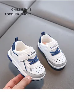Detailed side view of white and blue breathable toddler sneakers with velcro straps