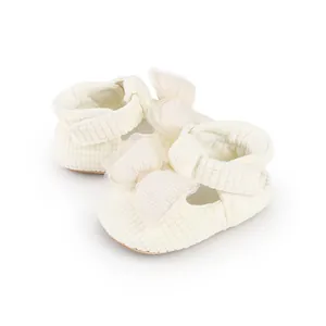Soft cream textured baby walking shoes with a delicate bow detail for infants aged 0-1 year