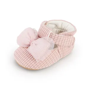 Detailed view of pink baby walking shoe with decorative mesh bow