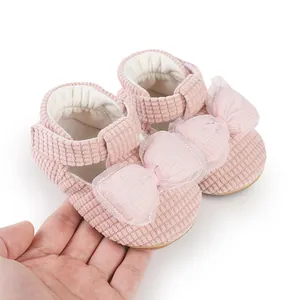 Detailed macro view of pink baby walker shoes with a large soft mesh bow decoration
